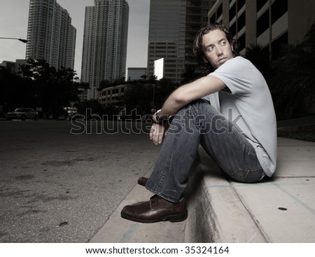 Man sitting on a curb