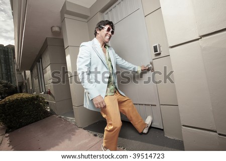 Funky male trying to pull the door open