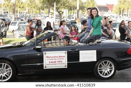 MIAMI, FL - NOVEMBER 21: Local Channel 10 news anchors waving to the crowd of the holiday parade at the Falls Mall Holiday Parade November 21, 2009 in Miami, FL.