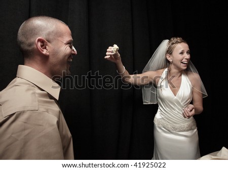 Bride and groom enjoying cake at the wedding.  Image part of wedding series 1