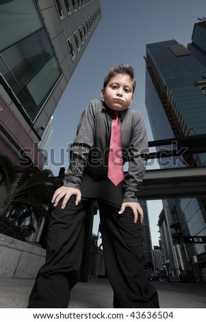 Young boy bending forward to look at the camera