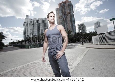 Handsome young male model posing on the street corner