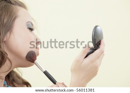 Woman applying blush makeup