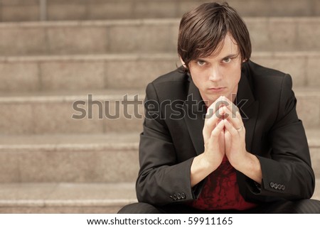 Man with hands clasped together