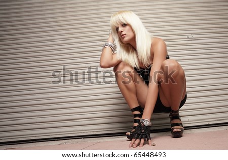 Woman squatting and looking at the camera
