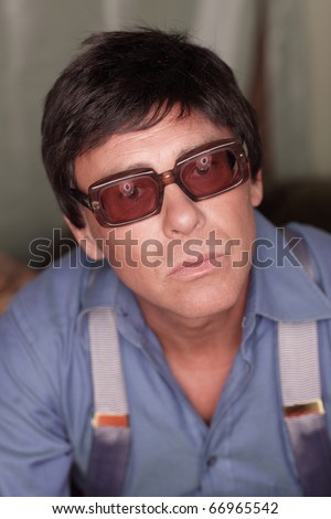 Headshot of a man with vintage prescription glasses