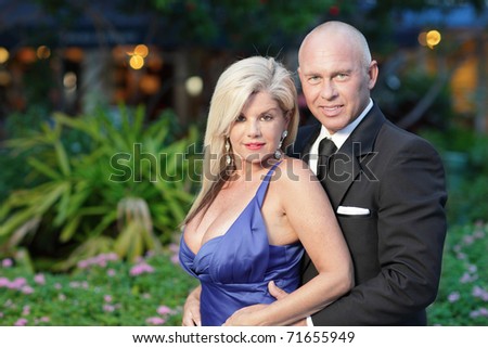 Attractive mature couple posing in formal attire