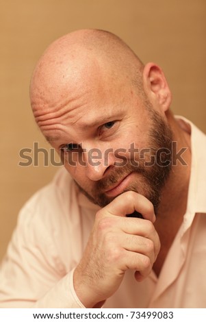Man touching his chin and smirking