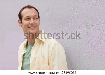 Handsome man smiling and looking over shoulder