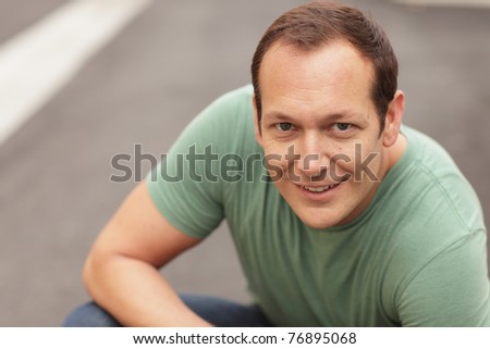Man crouching and smiling