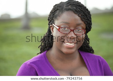 Black female wearing glasses and smiling