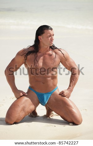 Handsome body builder on the beach
