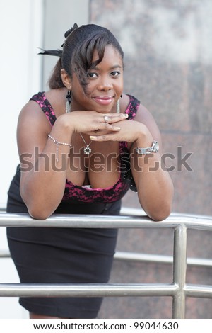 Woman smiling and leaning on a rail