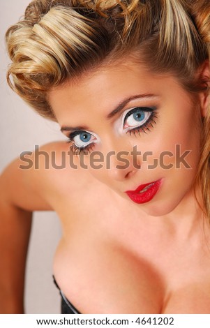 Close-up portrait of beautiful blond female with blue eyes and red lips