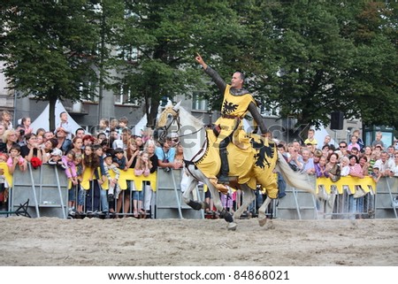 RIGA, LATVIA - AUGUST 21: Member of The Devils Horsemen stunt team riding horse and showing stunts during Riga Festival on August 21, 2011 in Riga, Latvia
