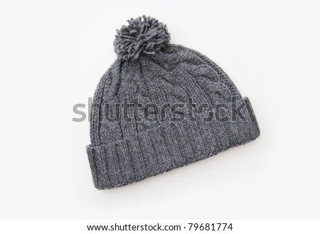 Gray knitted wool hat with Pom Pom isolated on white background