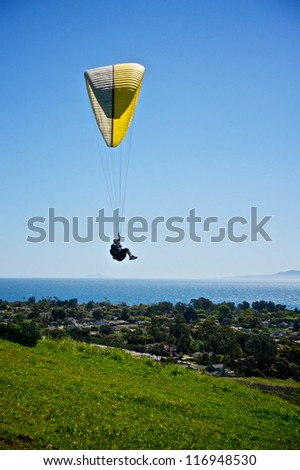 Paraglider flies through the air above the city of Santa Barbara, California.