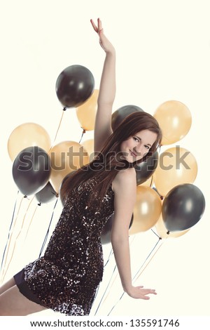 Party Time!  Attractive teen in a party dress with gold and black balloons.
