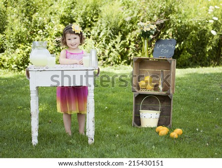 Adorable little girl running a lemonade stand.