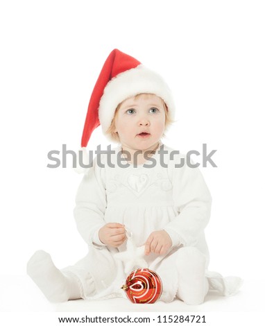Cute baby girl in Santa\'s hat playing on the floor