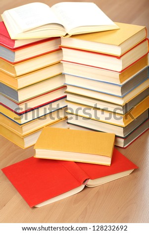 Many stacked books on the floor