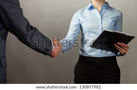 Handshake of business partners - man and woman