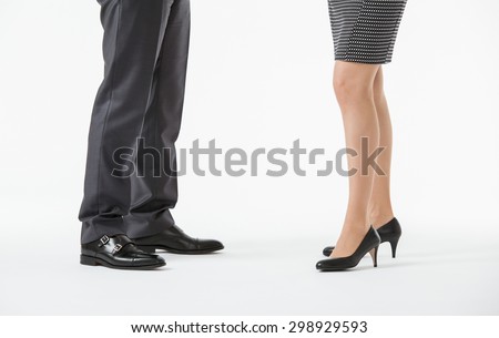 Closeup of businessman\'s and businesswoman\'s legs on the floor