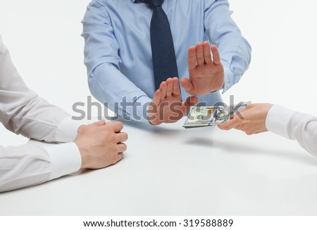 Businessman refusing money, white background