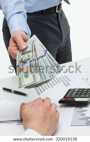 Businessman offering money to business partner, white background