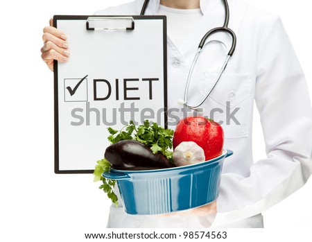 Doctor prescribing healthy natural food; closeup of doctor\'s hands holding clipboard with marked checkbox \
