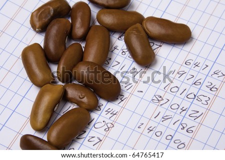 Accounting ledger book with a pile of beans.  Accounting theme.