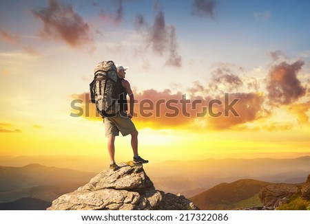 Tourist on high rocks. Sport and active life concept