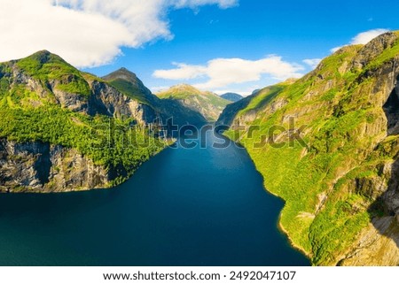 Similar – Image, Stock Photo A fjord in Norway. In the foreground the sea and in the background snow-covered mountain tops. The blue sky is decorated by veil clouds.