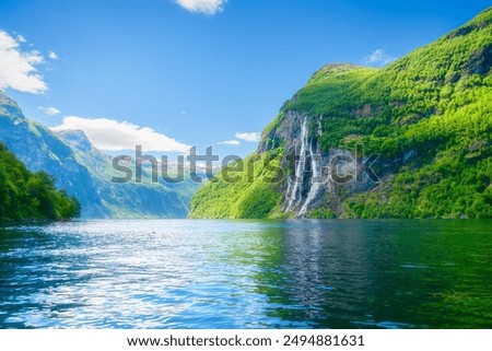 Similar – Image, Stock Photo A fjord in Norway. In the foreground the sea and in the background snow-covered mountain tops. The blue sky is decorated by veil clouds.