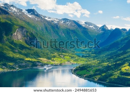 Similar – Image, Stock Photo A fjord in Norway. In the foreground the sea and in the background snow-covered mountain tops. The blue sky is decorated by veil clouds.