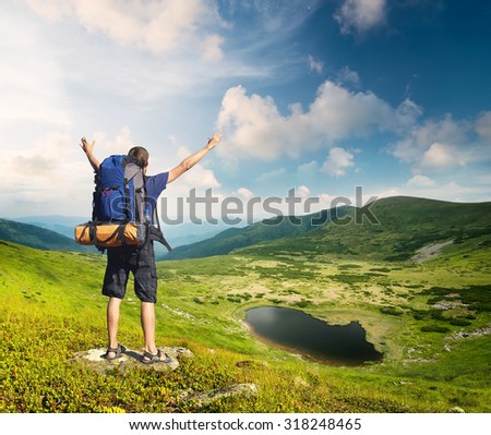 Tourist in mountain valley in the summer time. Sport and active life concept