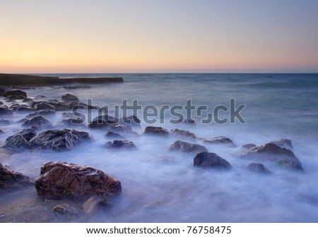 Stones and mist on the beach during sunset. Composition of nature
