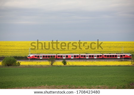 Similar – Image, Stock Photo Passenger train and rapeseed field. Spring landscape at sunrise