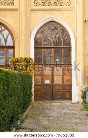 Historical Wooden Door with Glass Panes and Bushes Around, Prague, The Czech Republic