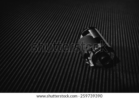 Camera film roll design on blue background, black and white picture