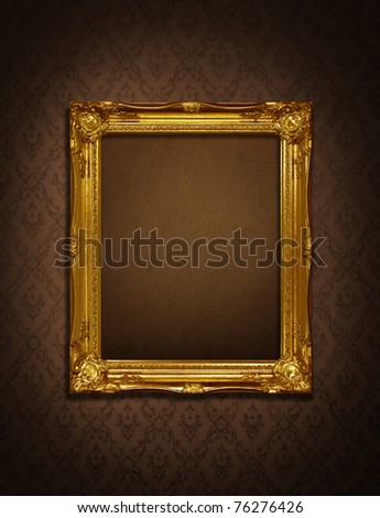 Gold frame stuck on the wall wallpaper thai the dark.