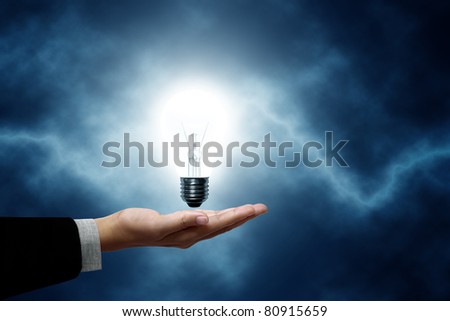 Light bulb hanging on business men. The background is a blue lightning bolt
