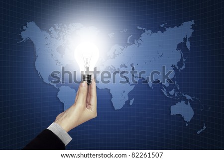 Bulb light in hand on world map blue background