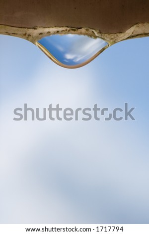 Shallow DOF water drop hanging from a edge about to drop, with clipping path included.