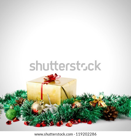 Golden christmas gift box with christmas balls over white background