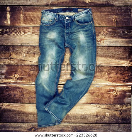 Blue jeans trouser over brown wood planks background