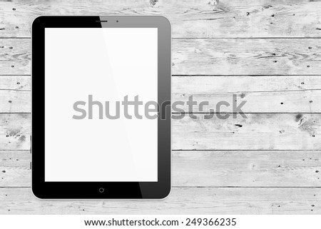 Black tablet pc same with ipade on wood background