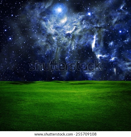 Green field under night  star sky. Beauty space nature background. Elements of this image furnished by NASA