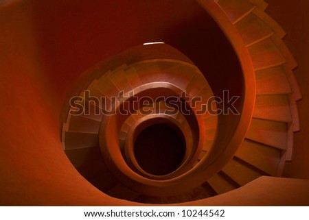 Red stone spiral stairs looking down the middle