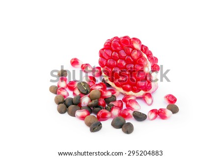 red sliced pomegranate with coffee grains and  red pomegranate grains on a white background isolated